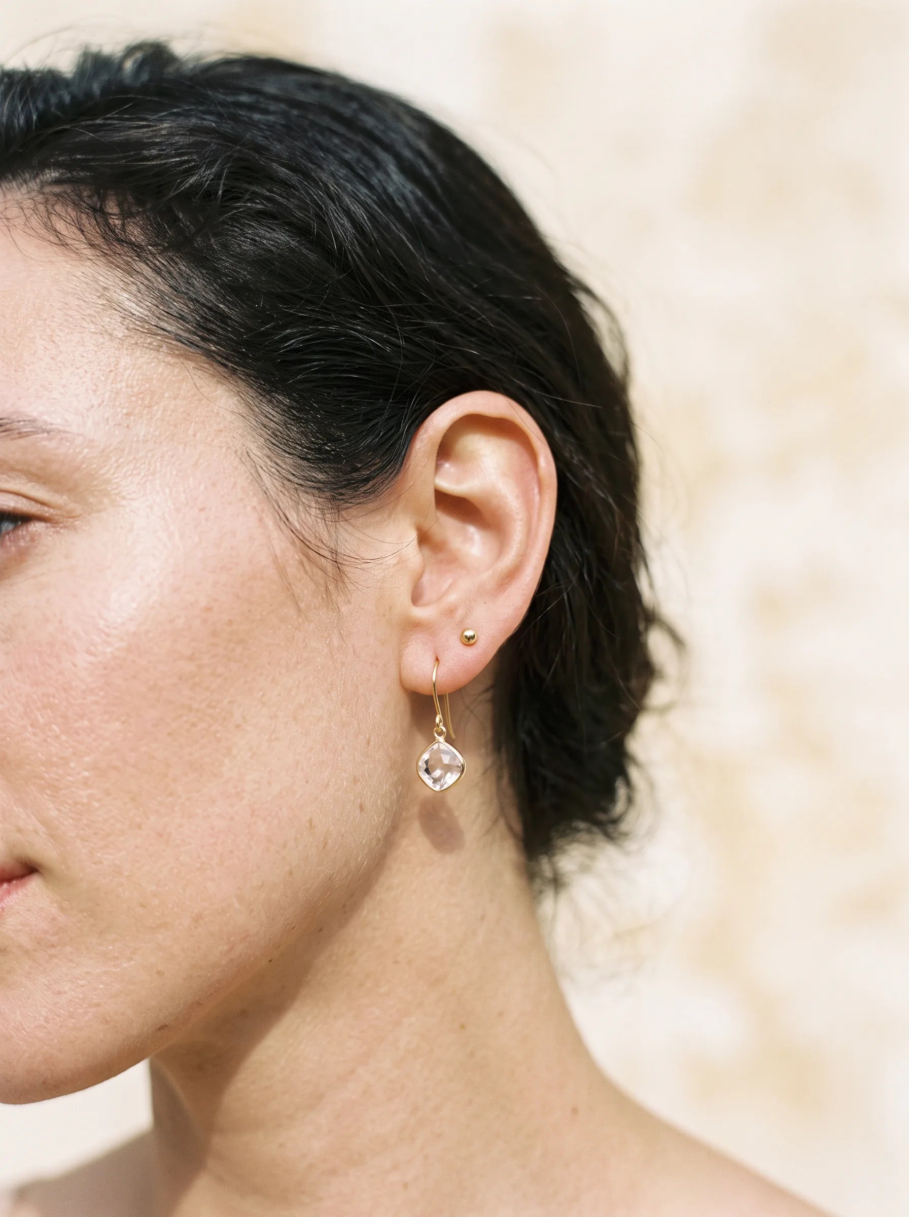 Delicate drop earring catching the light