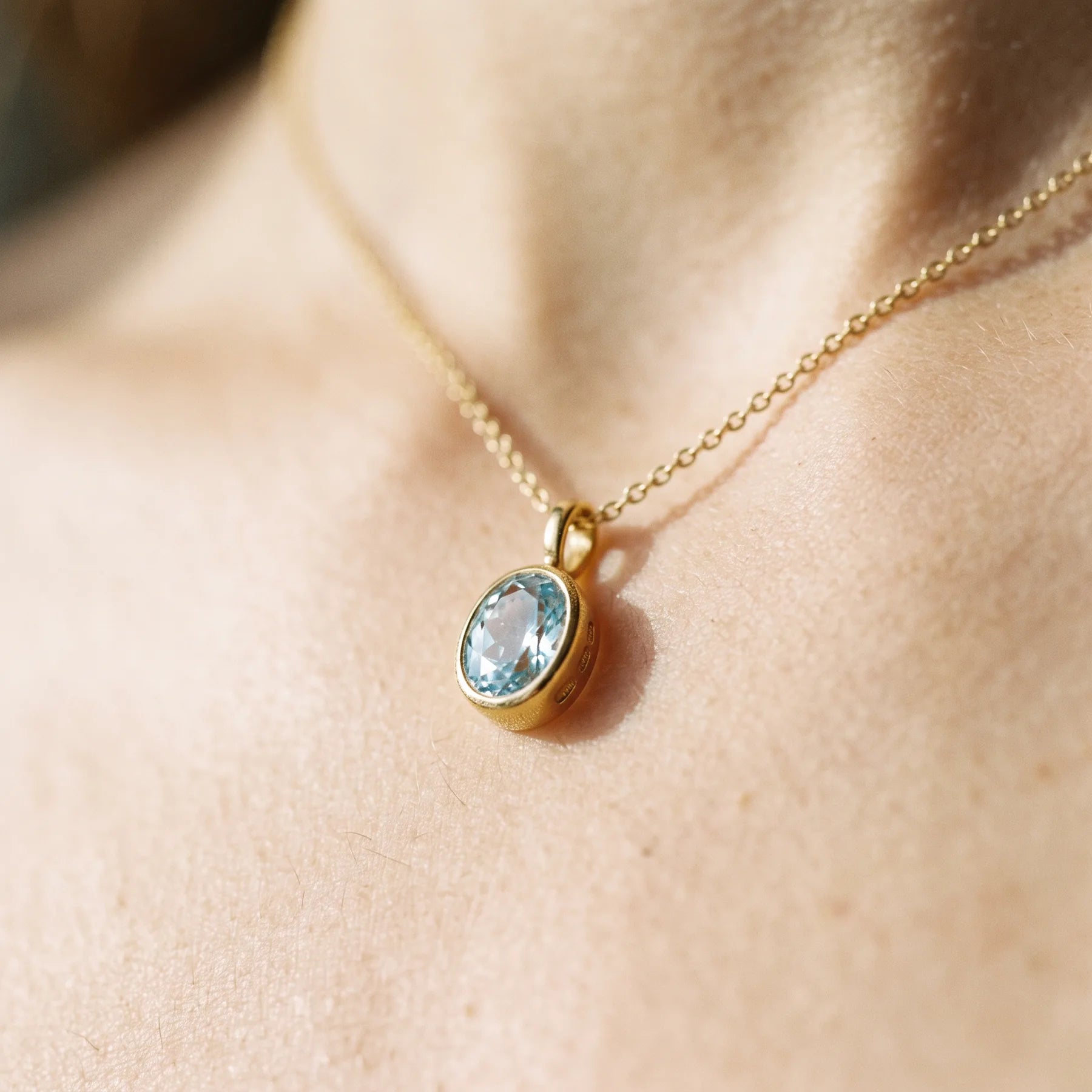 Close detail of a fine chain against skin