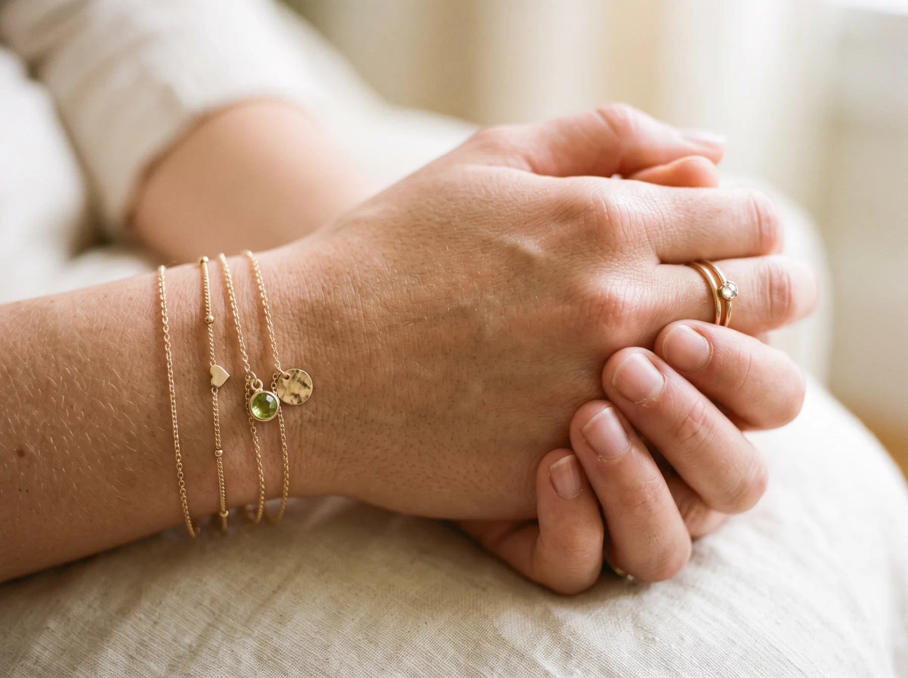 Two hands, one holding the other's wrist